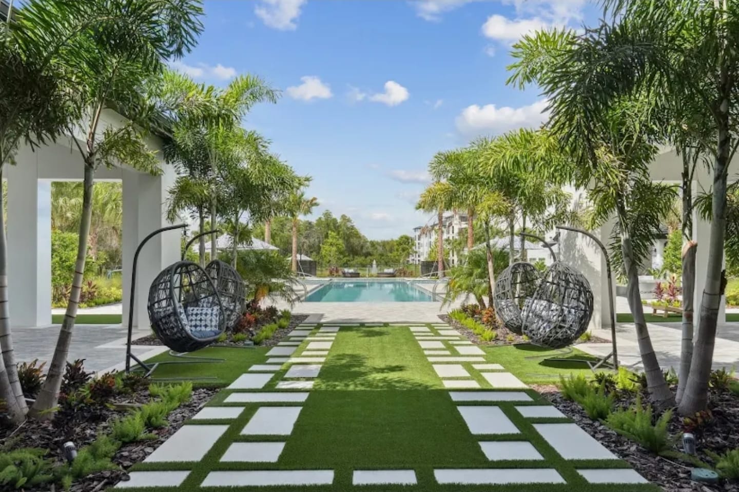 Synthetic turf walkway with pavers by the pool