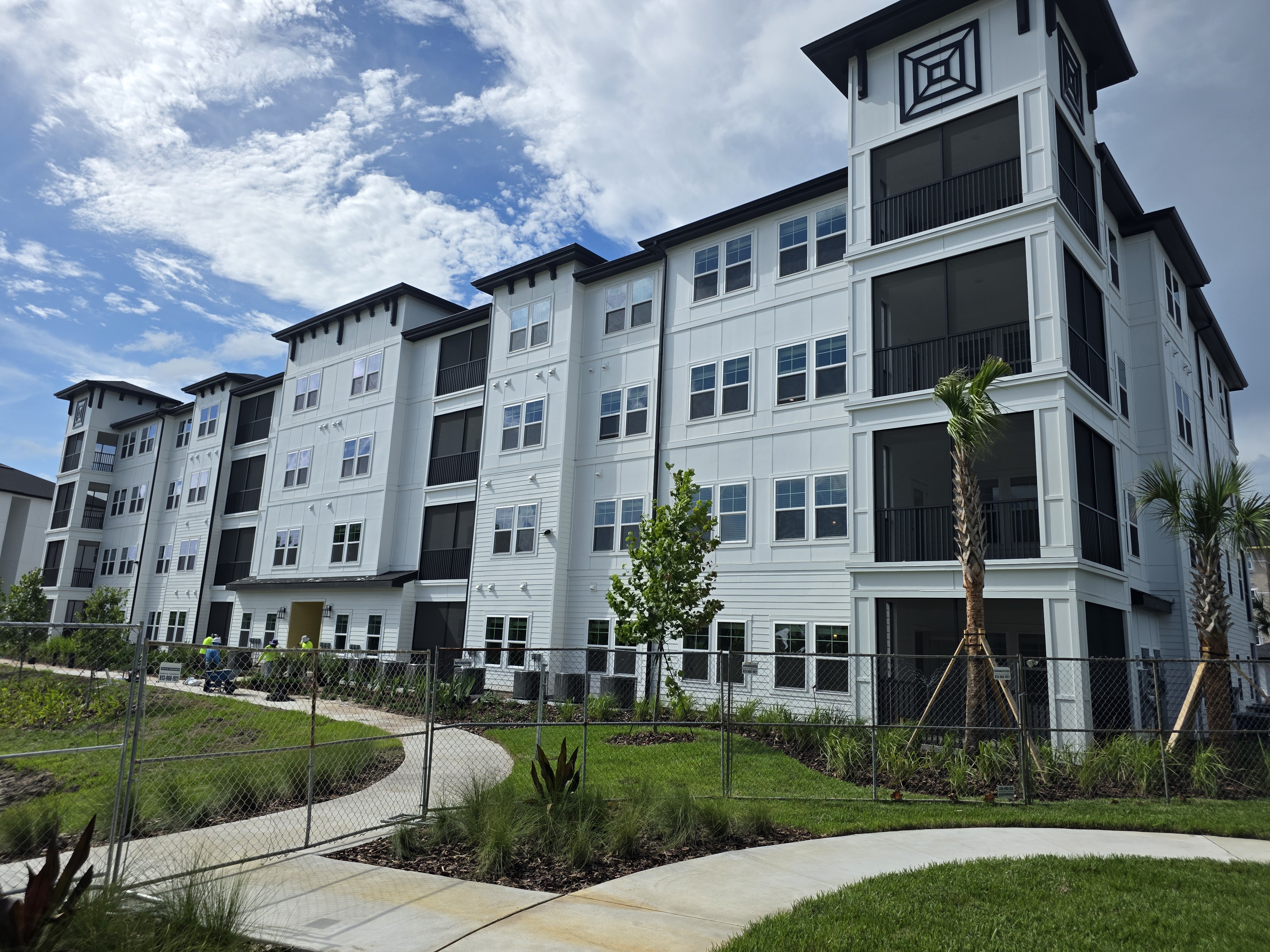 Multifamily building with screen balconies and aluminum railings in Florida